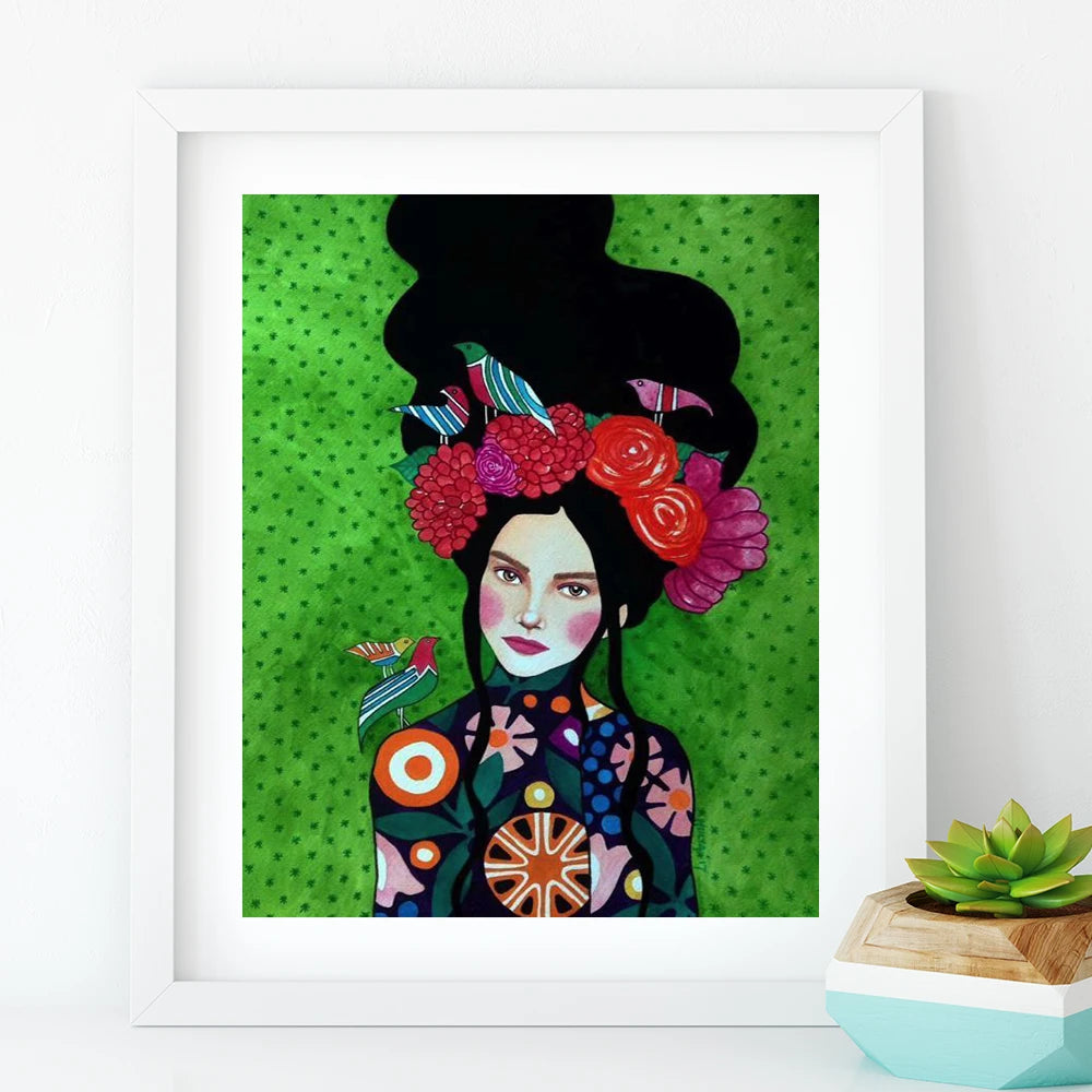 Framed artwork of a stylized woman with floral headpiece on a green background