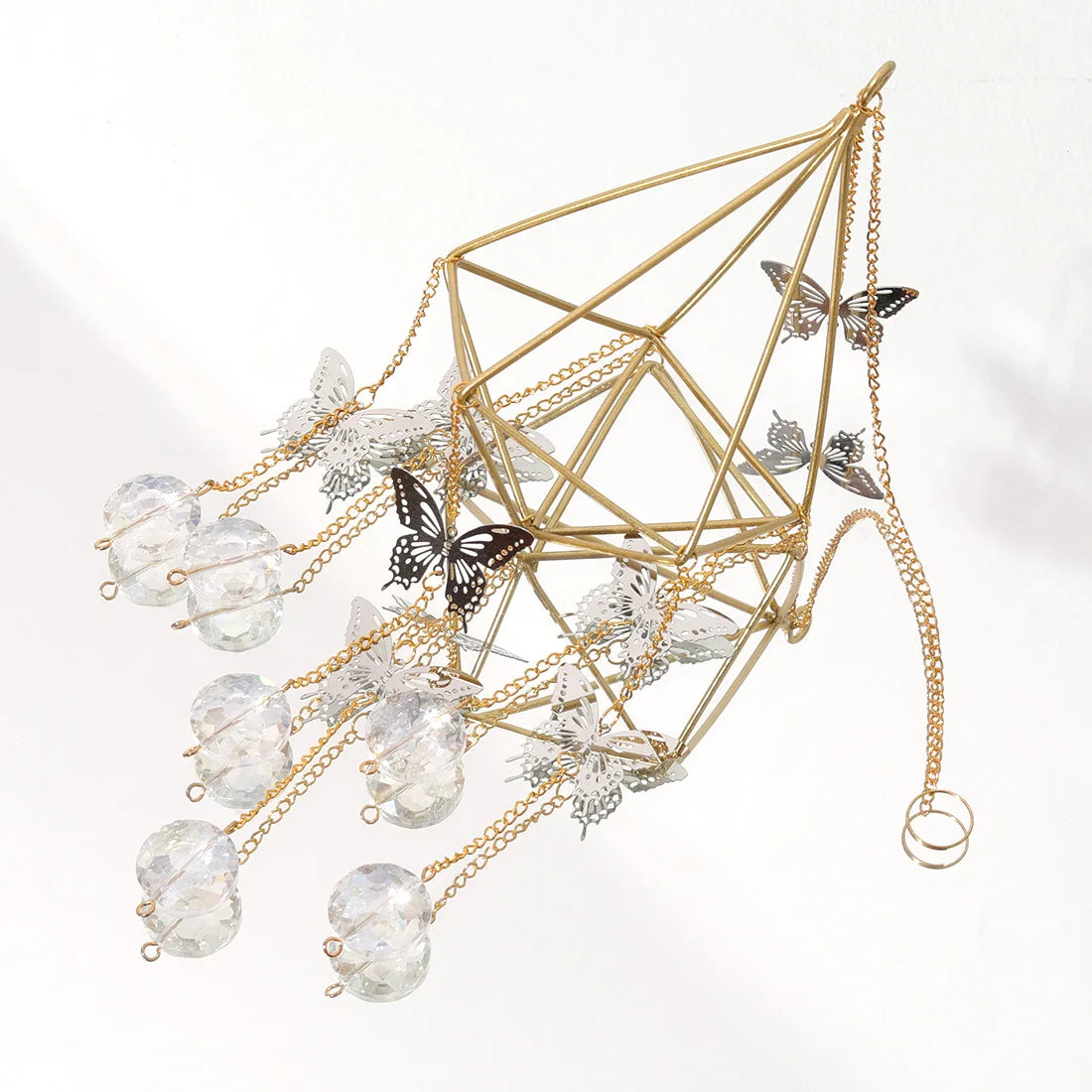 Gold geometric necklace with crystal beads and butterfly pendants on a white background