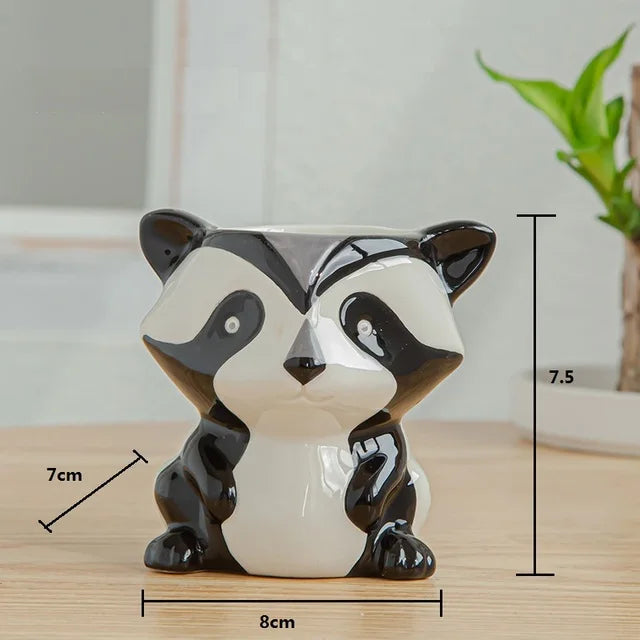 Ceramic badger planter with measurements on a wooden surface
