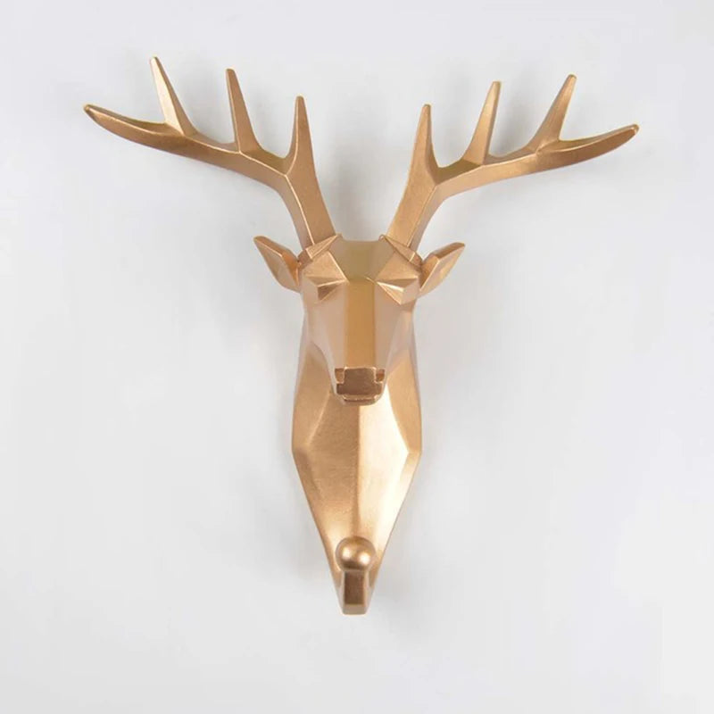 Gold deer head wall hook ion on a white background