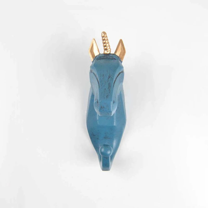 Blue decorative unicorn head hook with gold horns on a white background