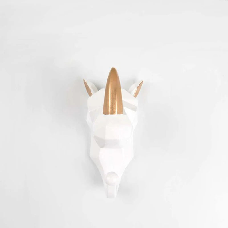Unicorn-shaped wall hook with gold horn on a white background