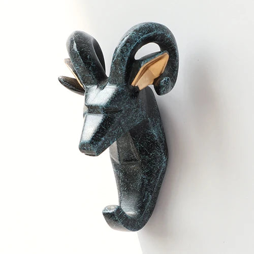 Decorative wall hook shaped like a ram's head on a white background