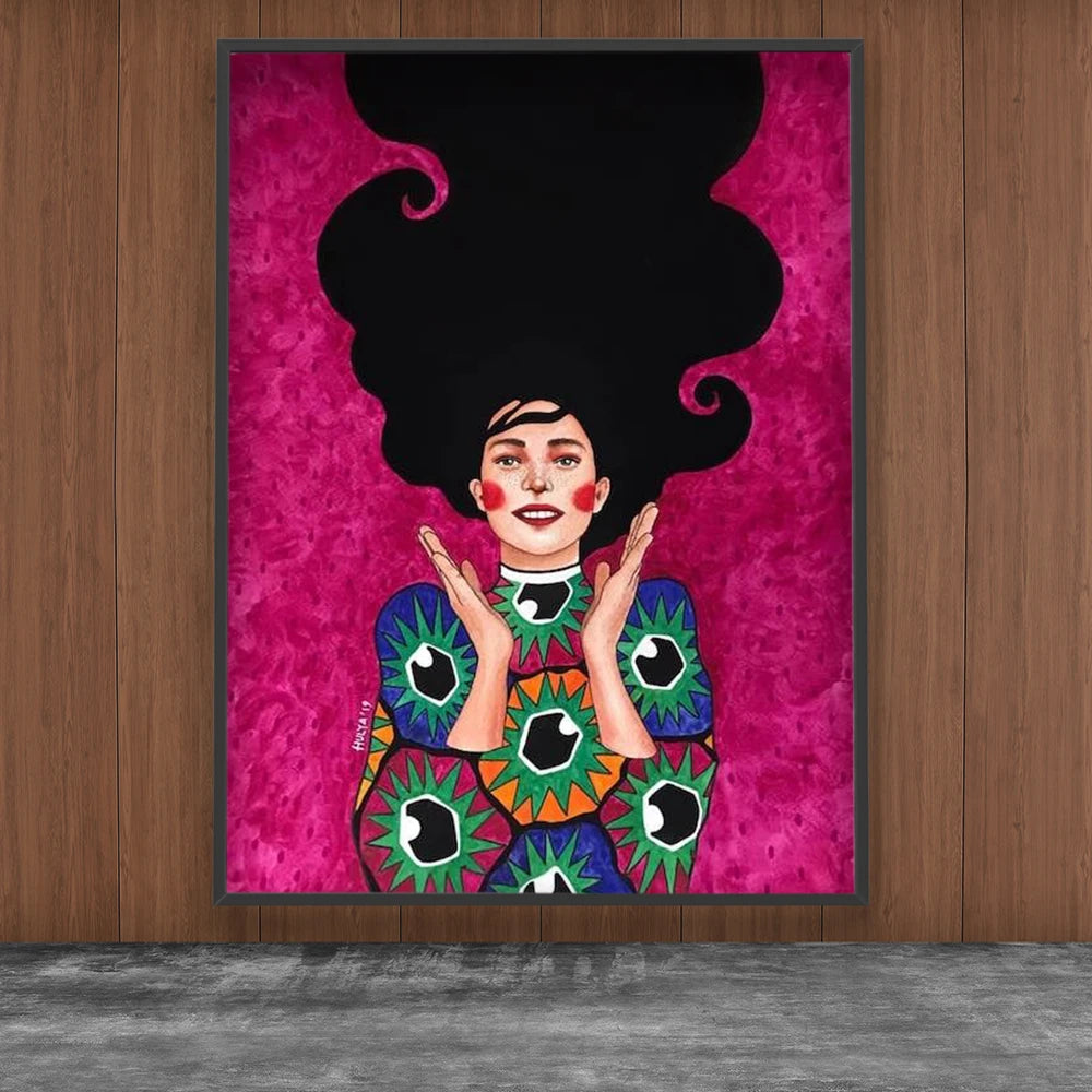 Framed artwork of a woman with large black hair on a pink background, displayed on a wooden wall.