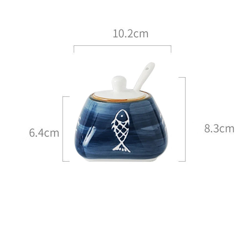 Blue ceramic container with fish design and spoon, shown with dimensions on a white background