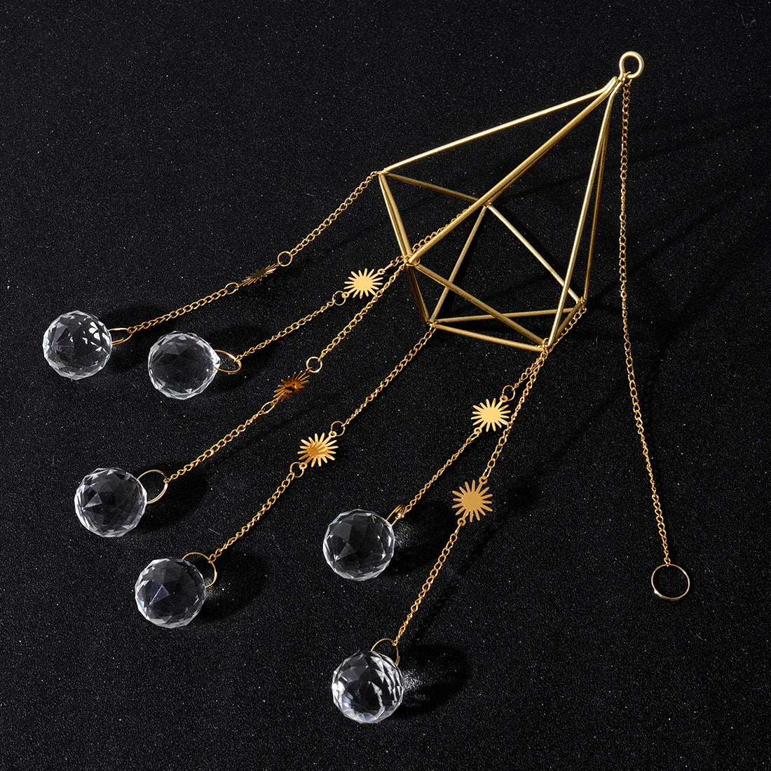 Decorative hanging crystal and geometric design on a black background