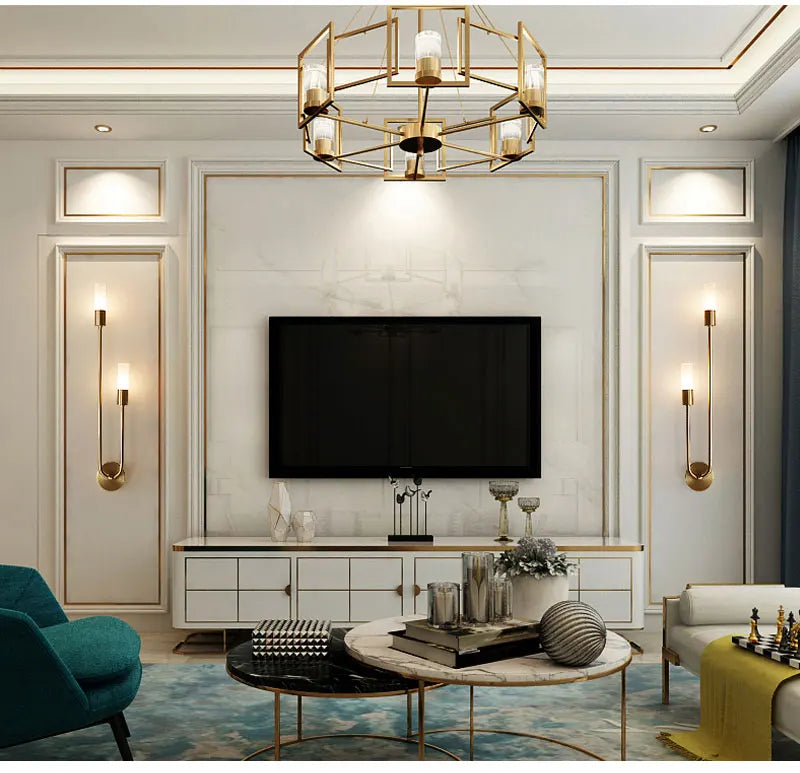 Modern living room with a television, decorative items, and stylish lighting fixtures.