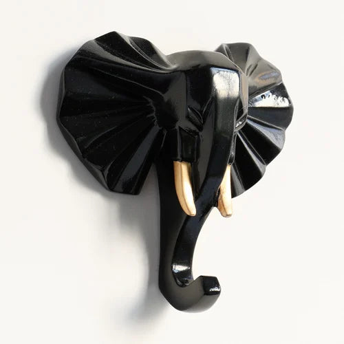 Black elephant-shaped wall hook with gold accents on a white background