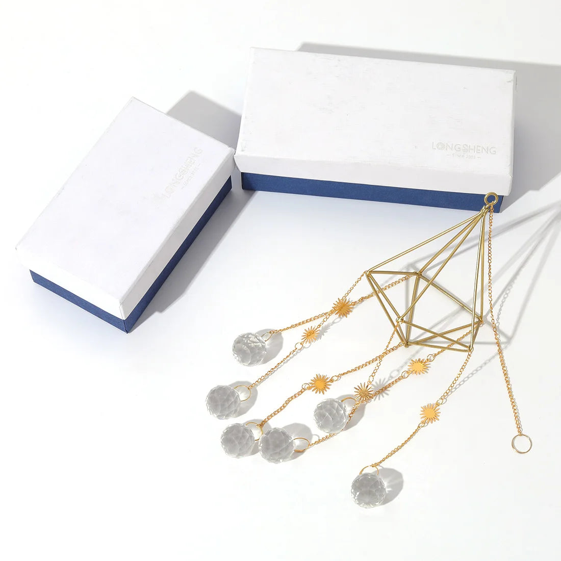 Gold and silver necklace with geometric design on a white background