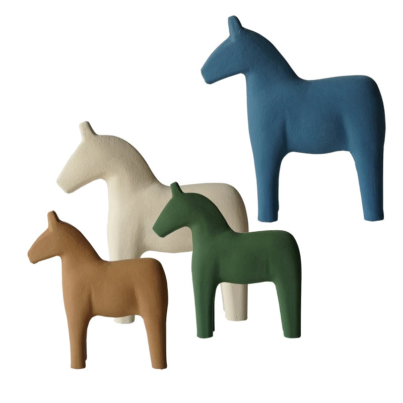 Four colorful horse figurines on a white background