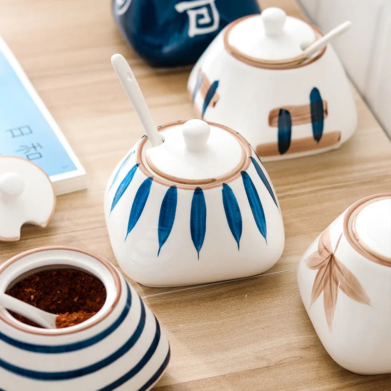 Set of ceramic containers with lids on a wooden surface