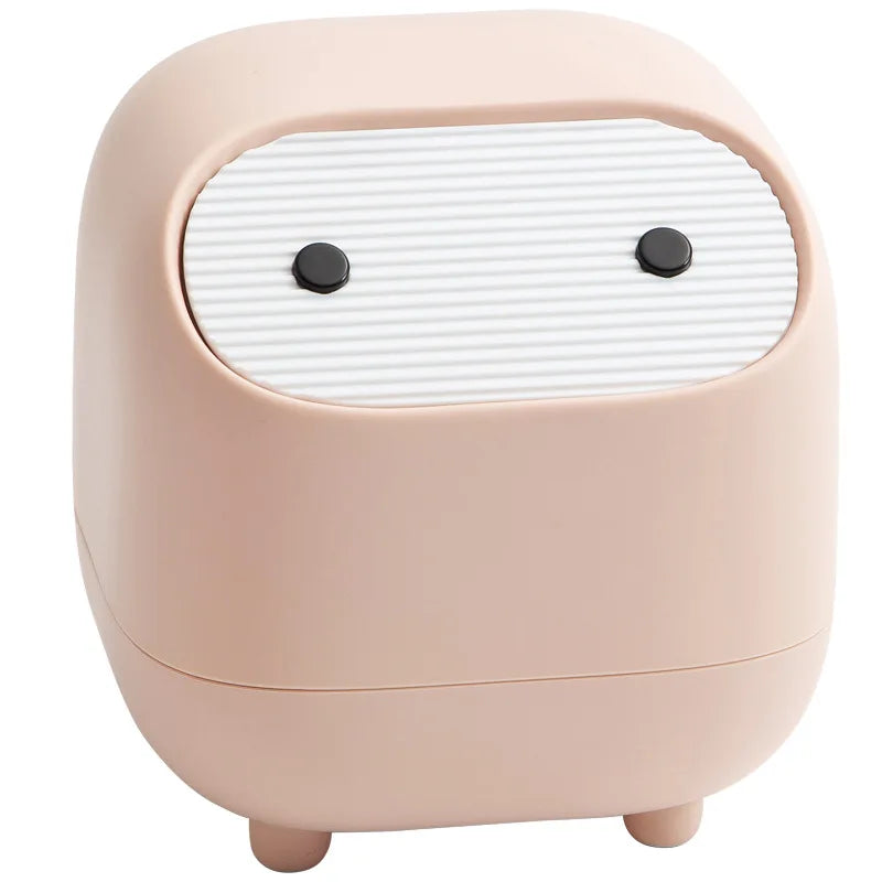 Pink speaker with a face design on a white background