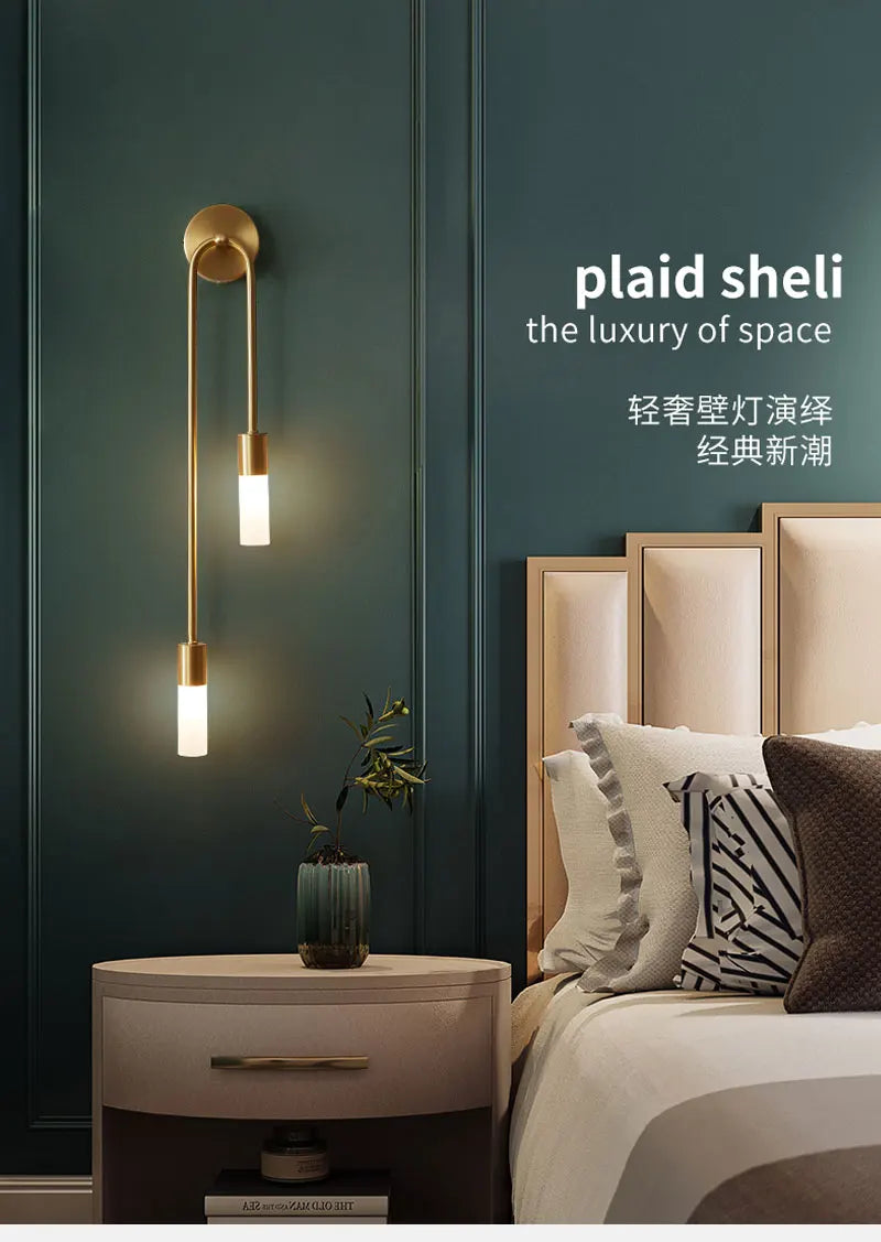 Modern bedroom with wall-mounted light fixture and 'plaid sheli' branding.