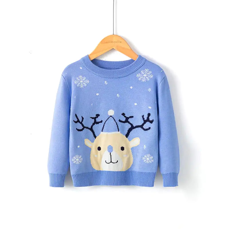 Blue sweater with reindeer design on a hanger against a white background
