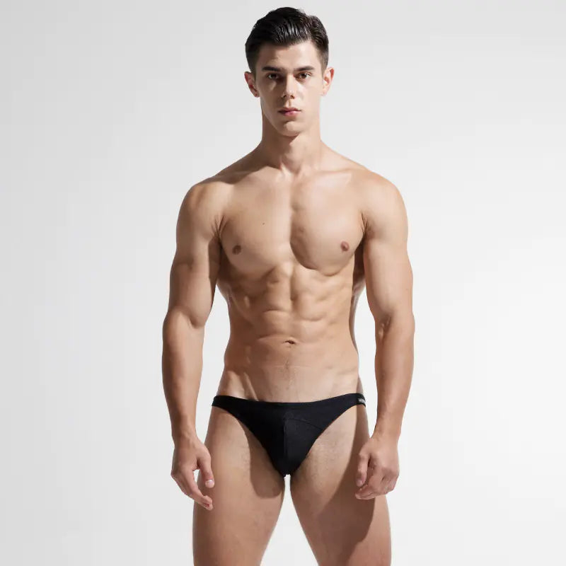 Man wearing a black swimsuit on a white background