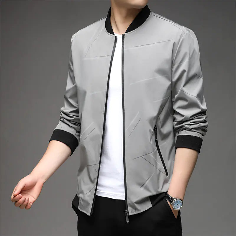 Gray bomber jacket with black accents worn by a person on a gray background