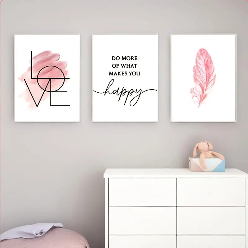 Three framed prints on a wall above a white dresser with a toy.