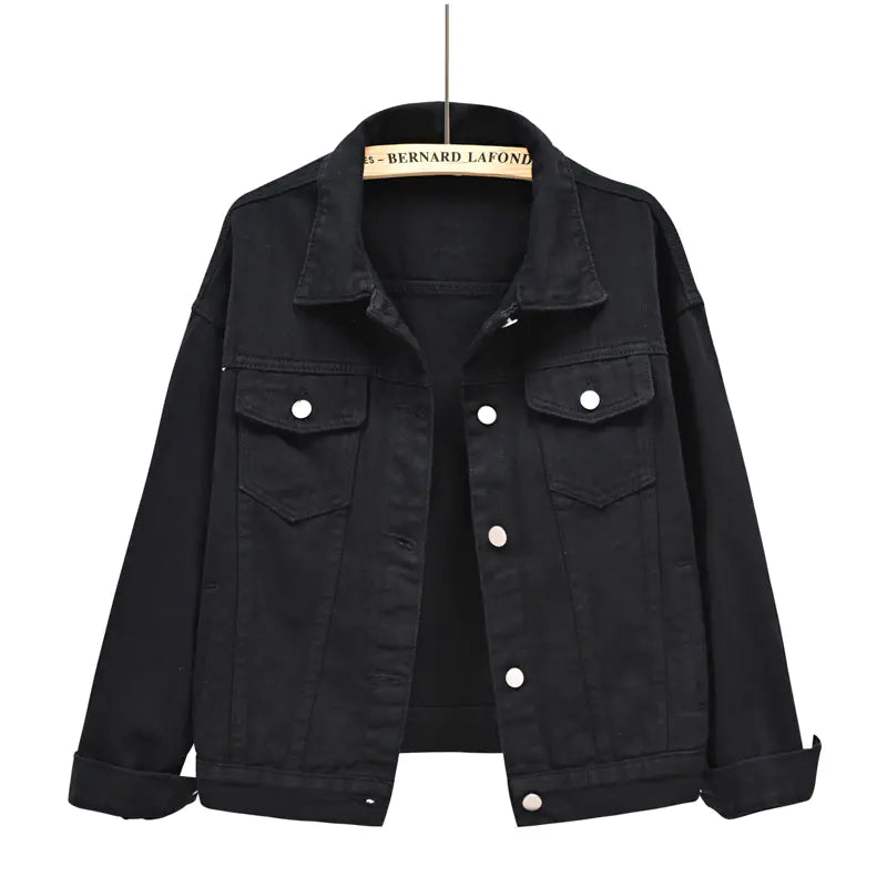 Black denim jacket on a hanger with a white background
