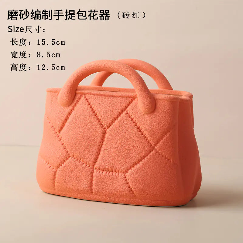 Orange handbag-shaped flower pot with size specifications on a beige background