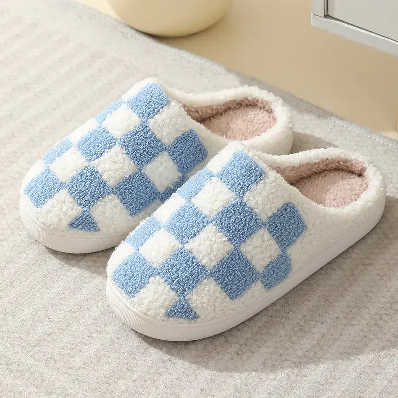 Pair of checkered slippers on a textured surface