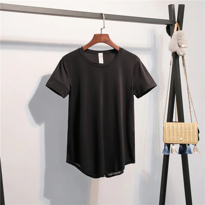 Black t-shirt on a hanger with a gold handbag in the background