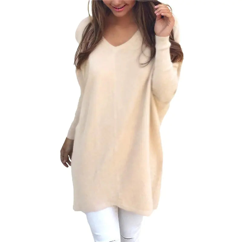 Beige long-sleeve top worn by a person on a white background