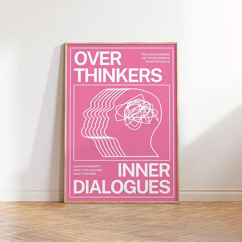 Framed poster with text 'Over Thinkers: Inner Dialogues' on a pink background, leaning against a white wall.