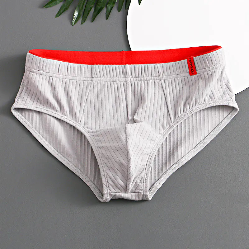 White underwear with red waistband on a gray background