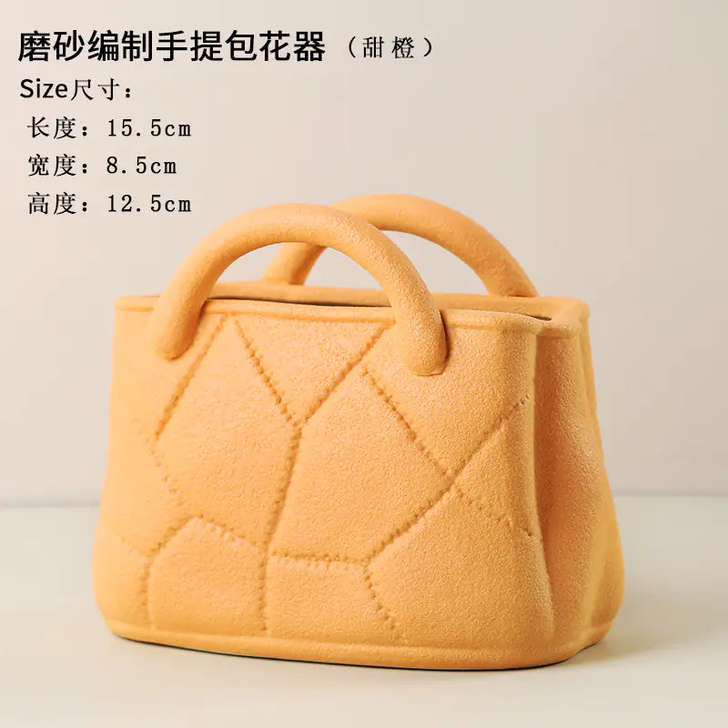 Yellow handbag with quilted design on a beige background