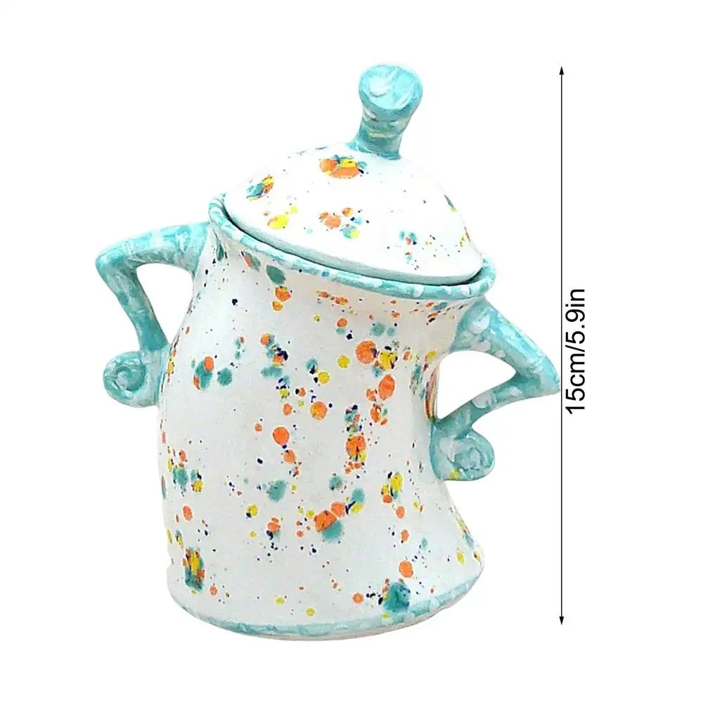 Ceramic jar with colorful speckles and turquoise accents, shown with dimensions on a white background.