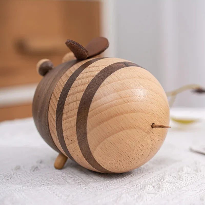 one handcrafted wooden bee toothpick holder with striped natural wood finish displayed on a wooden tabletop as decorative kitchen accessories.