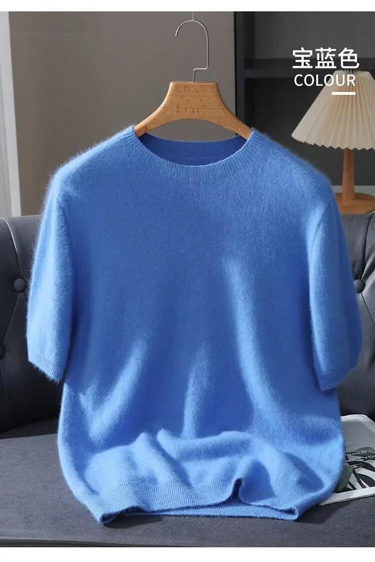 Blue sweater on a hanger against a neutral background