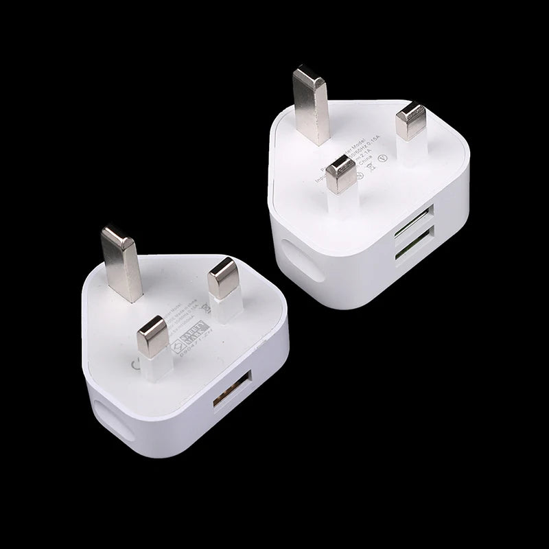 Two white plug adapters with multiple ports on a black background