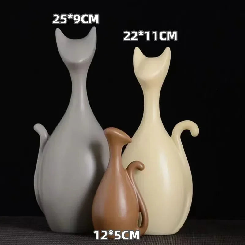 Three cat-shaped vases in different sizes on a black background
