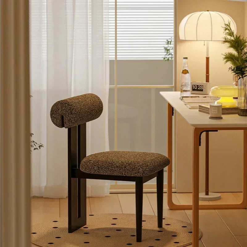 Brown chair in a room with a table and decor items