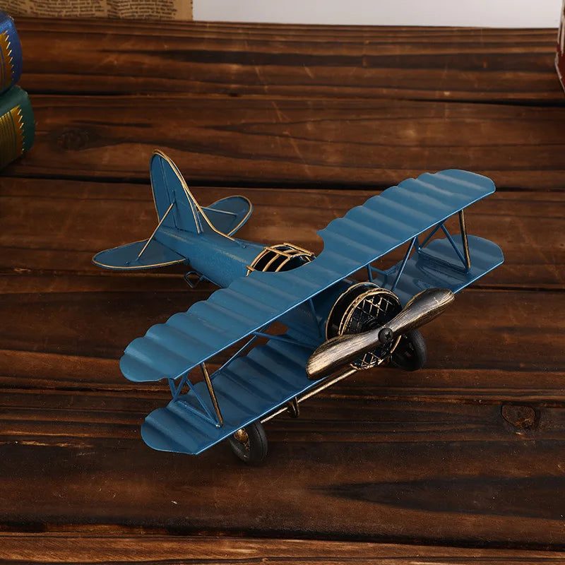 Vintage metal airplane ornament with a detailed retro aircraft design, available in red, yellow and blue for desk or shelf display.