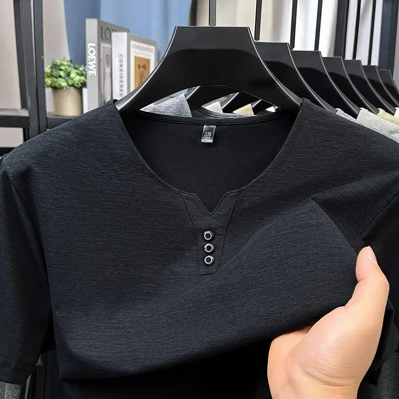Black shirt on a hanger with a blurred indoor background