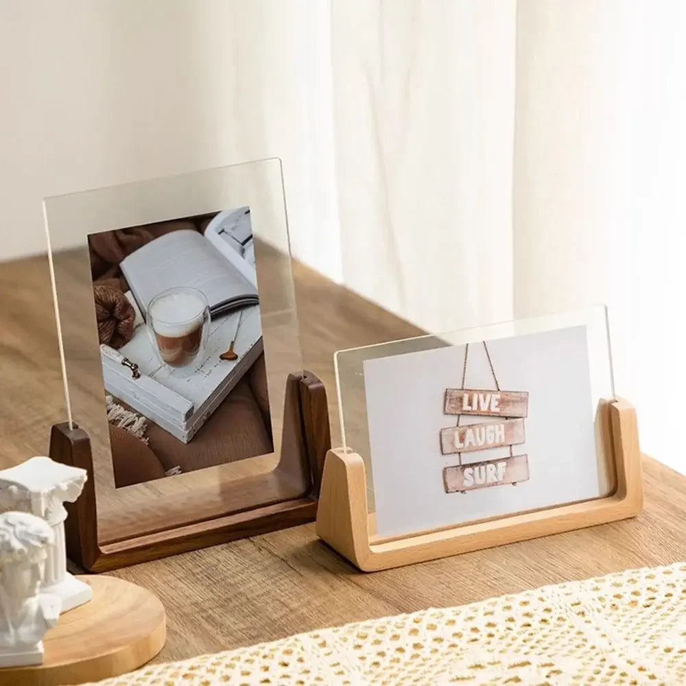 Two wooden photo holders on a table with one displaying a photo and the other with a motivational quote.
