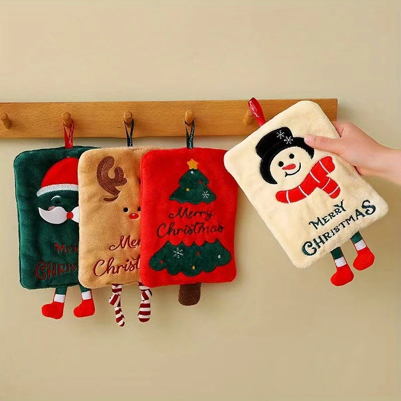 Set of Christmas-themed hand towels with decorative designs on a wooden rack.