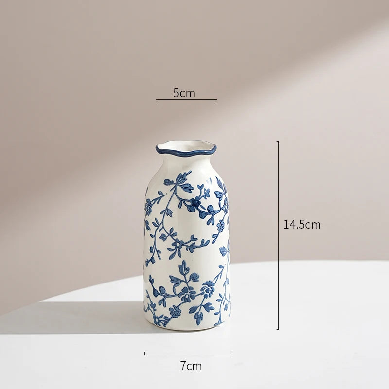 Ceramic vase with blue floral patterns on a beige background