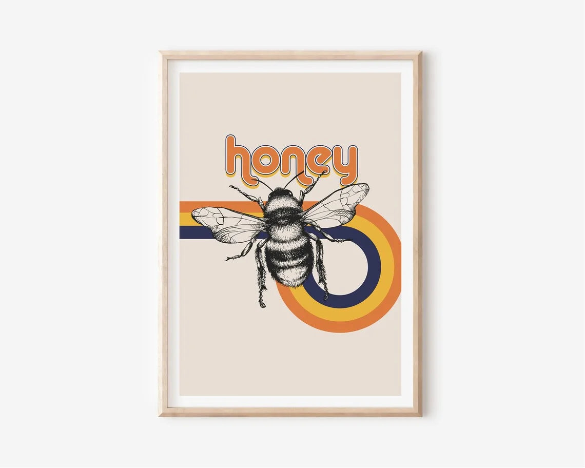 Framed artwork with a bee and 'honey' text on a rainbow background