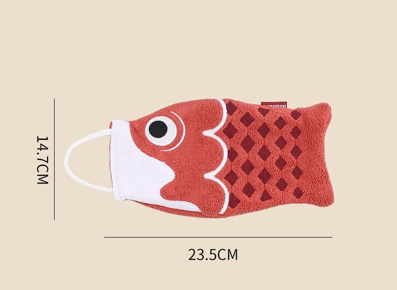 Red fish-shaped towel with measurements on a beige background