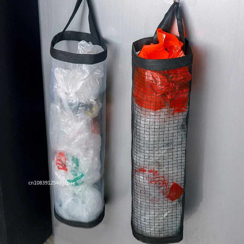 Two hanging trash bags, one with white plastic bags and the other with red and green bags, against a light gray wall.