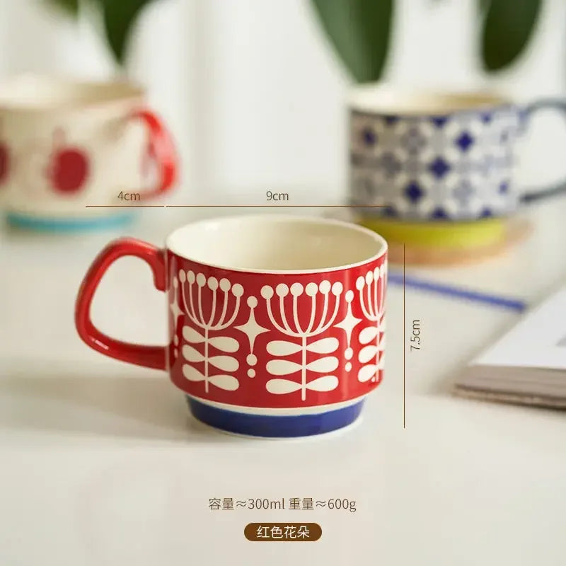 Red floral-patterned mug with measurements on a blurred background