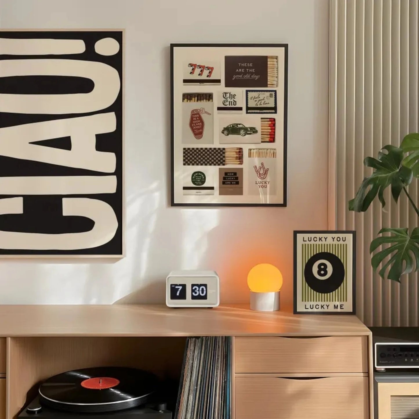 Set of three modern wall art prints featuring 8 ball, typography and graphic design displayed in a living room setting