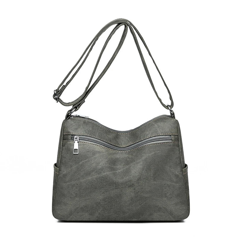 Gray shoulder bag with zippers on a white background