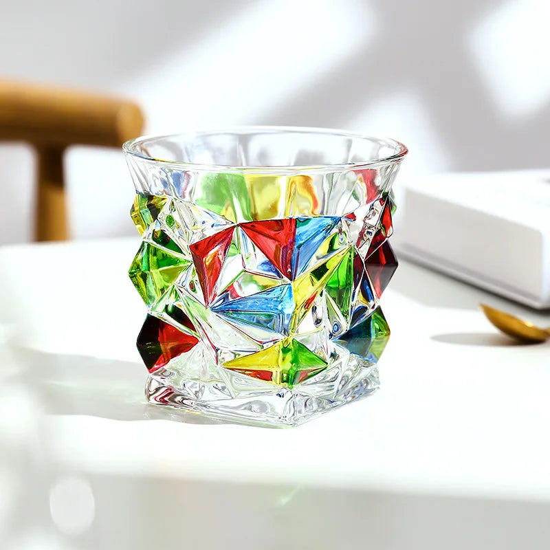 Colorful geometric-patterned glass on a white surface
