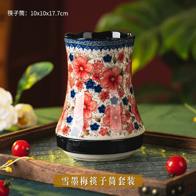 Decorative utensil holder with floral pattern on a wooden tray