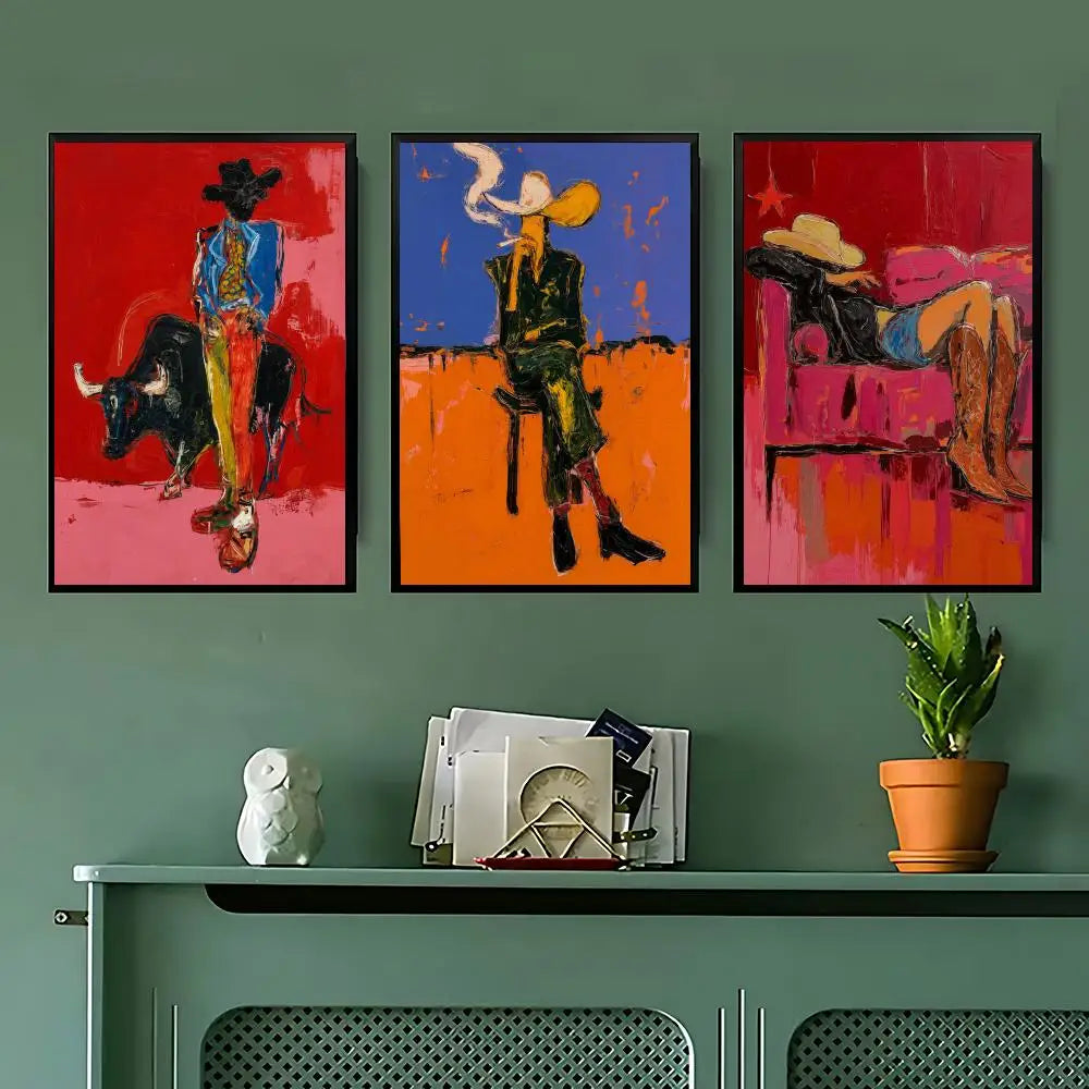 Three framed abstract paintings with bold red, orange, blue, and pink tones are displayed side by side on a sage green wall above a console table with decorative objects.