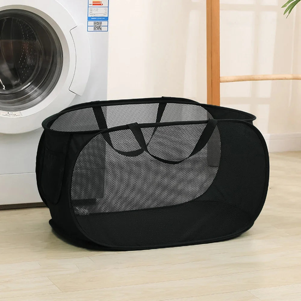 Foldable mesh laundry basket with handles shown being carried and filled with clothes in a home setting
